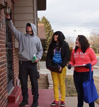 Groundwork Denver Take Charge Student Energy Ambassadors install energy efficient porch lightbulb