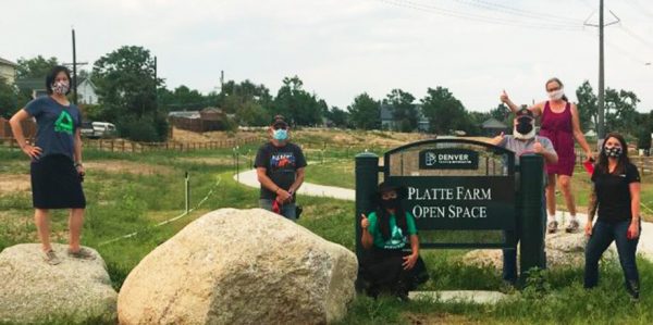 Groundwork Denver staff in front of Platte Farm Open Space sign 