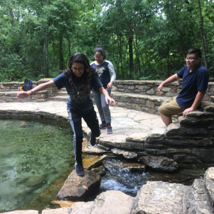 Dallas youth cross moving stream at Chickasaw National Recreation Area