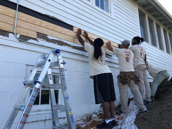 Repairing clapboard on the Skyway Club